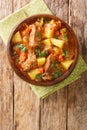 Italian beef stew with potatoes, carrots and celery close-up in a bowl. vertical top view Royalty Free Stock Photo