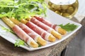 Italian breadsticks with ham. Tasty appetizer, mediterranean cuisine Royalty Free Stock Photo
