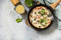 Rustic omelette (frittata) with mushrooms and bacon on a cast iron pan. View from above. Copy space