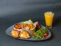 Italian breakfast - fried potatoes, beans, soft cheese and salmon sandwiches and rucola and tomato salad with pesto Royalty Free Stock Photo