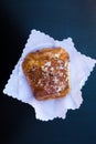 Italian breakfast. top view to fresh crunchy croissant or cornetto with glaze and chocolate on white napkins on black