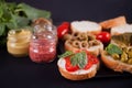 Italian bruschetta in assortment on the plate, set with small bottle of mustard