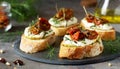 Italian bruschetta bread with cream cheese, zucchini and dried tomato with herbs. Canape with ricotta cheese