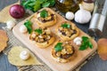 Italian bruschetta with champignons and caramelized red onions on a wooden background. Selective focus Royalty Free Stock Photo