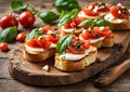 Italian bruschetta with fried tomatoes, slices of mozzarella and herbs on a wooden tray