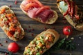 Italian bruschetta with roasted tomatoes, avocado, salmon, ham, peppers, herb Royalty Free Stock Photo