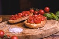 Italian bruschetta, toasted bred with fresh tomato and basil on woody vintage table