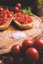 Italian bruschetta, toasted bred with fresh tomato and basil on woody vintage table