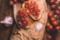 Italian bruschetta, toasted bred with fresh tomato and basil on woody vintage table