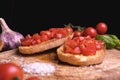 Italian bruschetta, toasted bred with fresh tomato and basil on woody vintage table