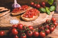 Italian bruschetta, toasted bred with fresh tomato and basil on woody vintage table