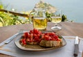 Italian bruschetta and white wine against the background of the Aragonese castle Ischia island Italy Royalty Free Stock Photo