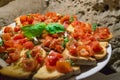 Italian bruschettas with chopped tomato and basil ready for breakfast