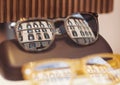 The italian building in the reflection of glasses. Display of colorful sunglasses for sale.