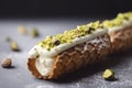 An Italian cannoli, with its crispy shell and creamy ricotta filling, is dusted with pistachio crumbs.Â 