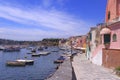 Panoramic view of beautiful Procida in sunny summer day. Colorful houses, cafes and restaurants, fishing boats and yachts in Marin Royalty Free Stock Photo