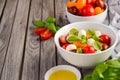 Italian Caprese salad with cherry tomatoes, small mozzarella and fresh basil Royalty Free Stock Photo