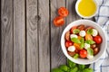 Italian Caprese salad with cherry tomatoes, small mozzarella and fresh basil Royalty Free Stock Photo