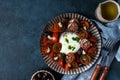 Italian caprese salad with sliced tomatoes, mozzarella cheese, olive oil on dark background. Top view. Black tomato Royalty Free Stock Photo