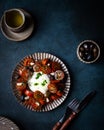 Italian caprese salad with sliced tomatoes, mozzarella cheese, olive oil on dark background. Top view. Black tomato Royalty Free Stock Photo