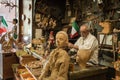 Italian carpenter working on Pinocchio wooden toys in his workshop/store