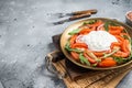 Italian cheese stracciatella burrata on plate with fresh tomatoes and arugula. Gray background. Top view. Copy space Royalty Free Stock Photo