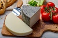 Italian cheeses, mature Tuscan Pecorino sheep cheese and Provolone dolce cow cheese served with olive bread and tomatoes Royalty Free Stock Photo