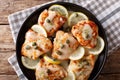 Italian chicken piccata with sauce, lemon and capers close-up on Royalty Free Stock Photo