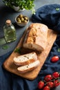 Italian ciabatta bread cut  slices with tomato, basil and olive on dark background.  Top view Royalty Free Stock Photo