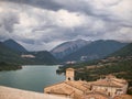 Italian city above a lake in a mountain valley. Amazing view of the blue lake.