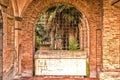 Italian cloister seen through an iron grate Royalty Free Stock Photo