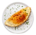 Italian closed pizza Calzone on a large white plate, isolated on white background Royalty Free Stock Photo