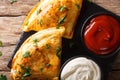 Italian closed pizza calzone with sauces close-up on the table. Royalty Free Stock Photo