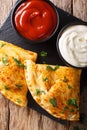 Italian closed pizza calzone with sauces close-up on the table. Royalty Free Stock Photo