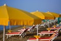 the yellow of the beach umbrellas and the blue sky