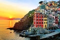 Colorful houses of Riomaggiore with setting sun over the sea, Cinque Terre, Italy Royalty Free Stock Photo