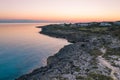 Italian coastline at sunset. Aerial view rocks and sea. calm water warm sky