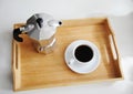 Italian coffee espresso maker moka pot and white cup of coffee on bamboo wooden tray Royalty Free Stock Photo
