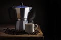 Italian coffee maker, cup of steaming coffee and whole beans on Royalty Free Stock Photo