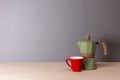Italian coffee maker and small cup on grey background Royalty Free Stock Photo