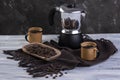 Italian coffee maker and two coffee mugs with roasted coffee beans in wooden container Royalty Free Stock Photo