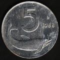 Italian coin valued five Lire with the image of a dolphin