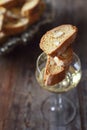 Italian cookies: almond cantuccini and glass of white wine