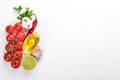 Italian cooking, fresh vegetables, cherry tomatoes. On a white wooden background. Royalty Free Stock Photo