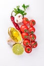 Italian cooking, fresh vegetables, cherry tomatoes. On a white wooden background. Royalty Free Stock Photo