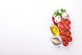 Italian cooking, fresh vegetables, cherry tomatoes. On a white wooden background. Royalty Free Stock Photo