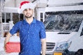 Italian courier holding a Christmas gift at outdoor
