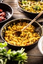 Italian creamy risotto with saffron , turmeric, or butternut in a pan with a wooden spoon