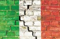Italian crisis concept image: Italy national flag painted on a cracked grungy brick wall.