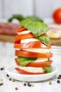Italian cuisine: caprese salad and breadsticks with ham Royalty Free Stock Photo